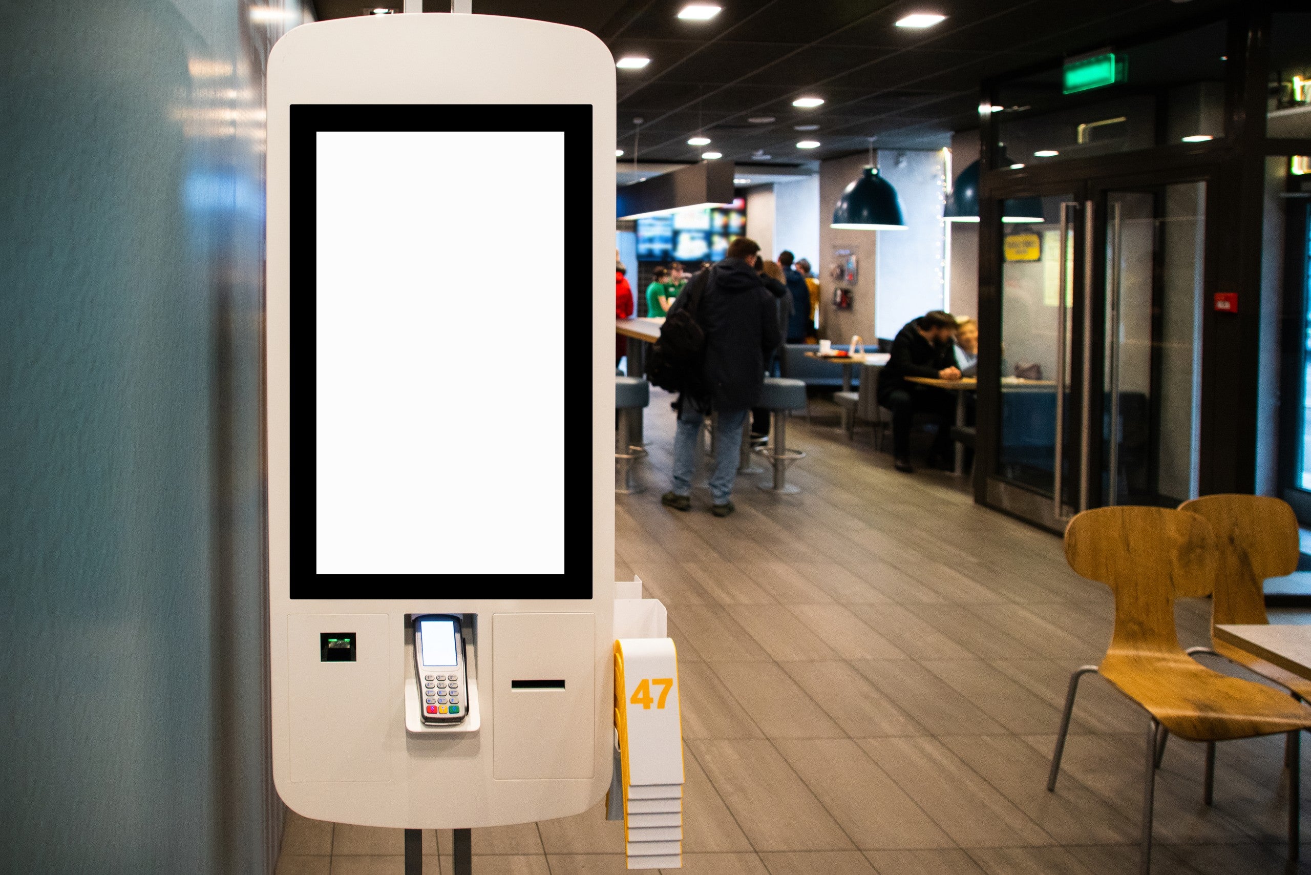 Self-service desk with touch screen in fast food restaurant